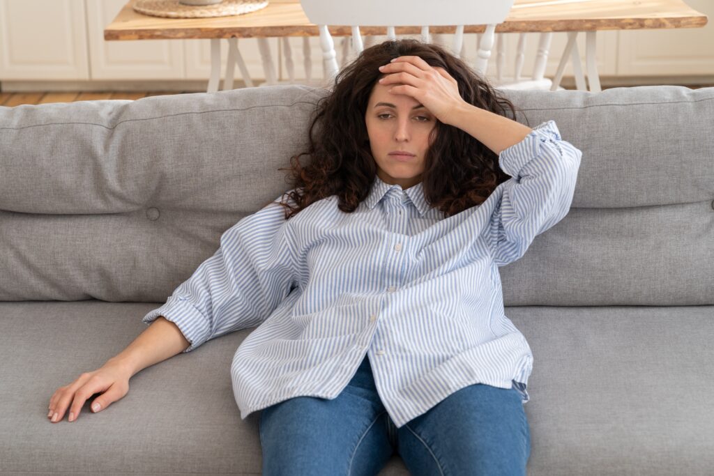 Woman exhausted on sofa